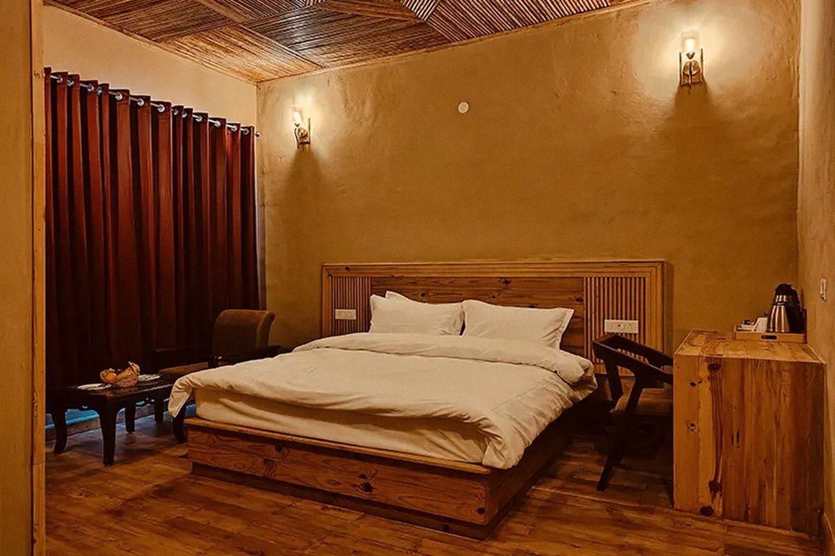 An earthen-walled room with a low bed