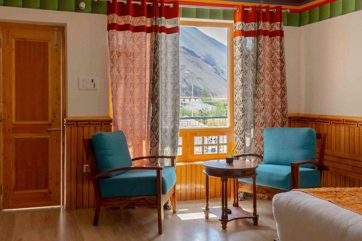 Two chairs at a window, the valley beyond