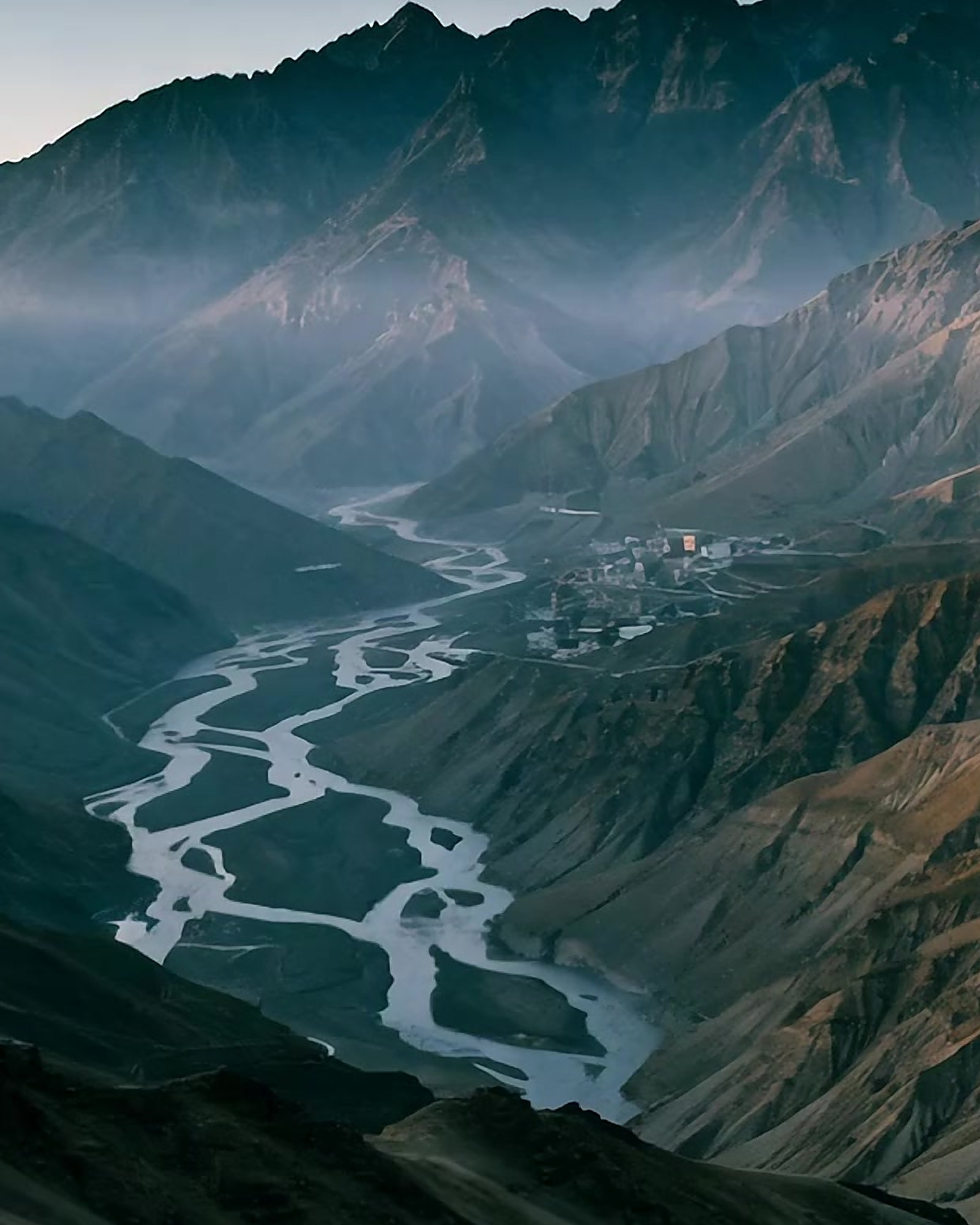 The Spiti valley at dusk, a braided river below a high village